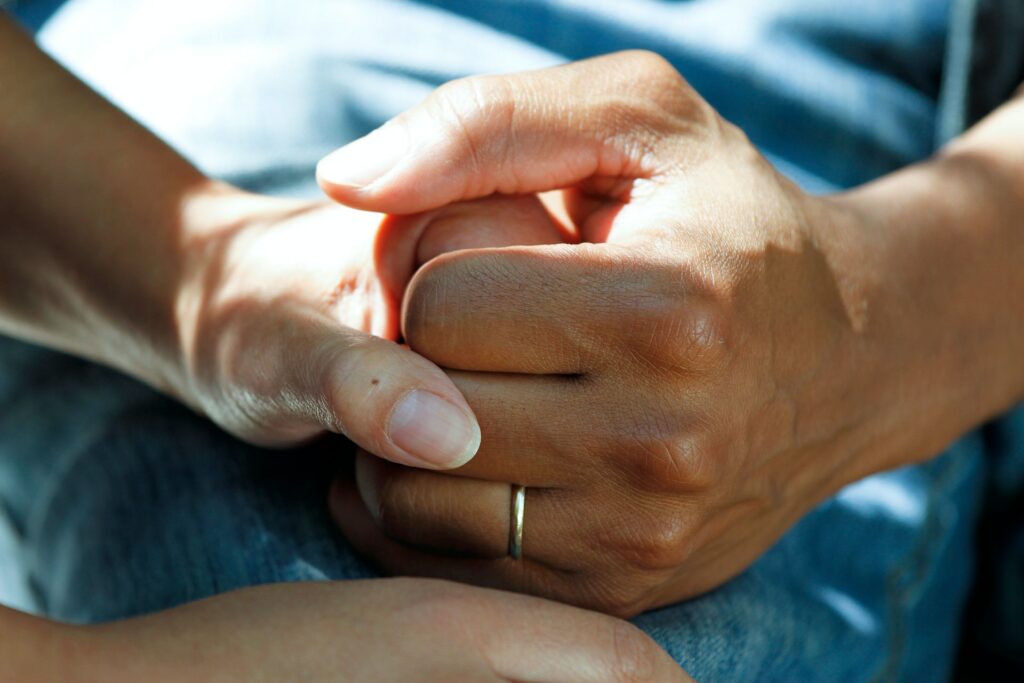 Nurse holding the hand of a patient